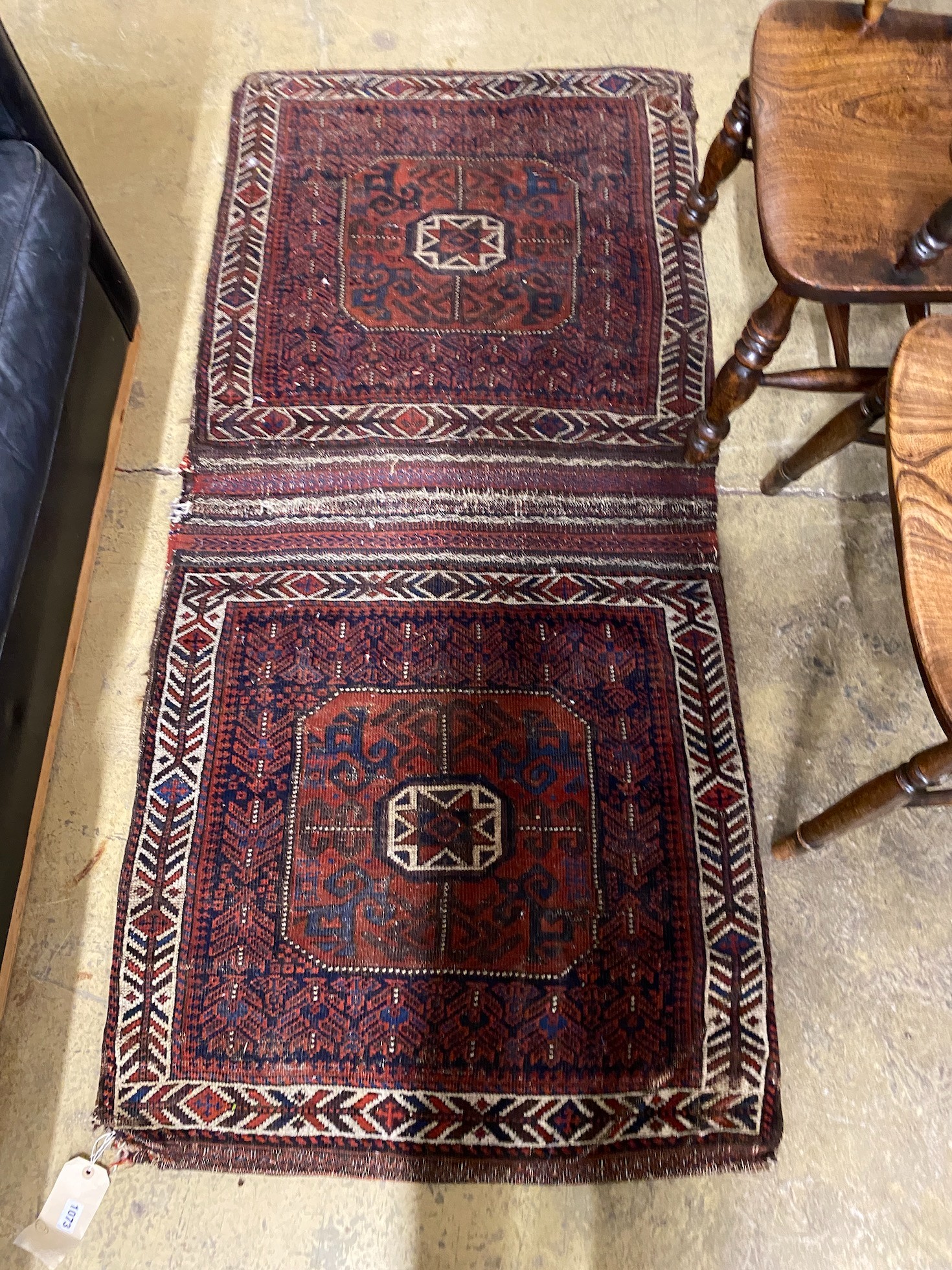 An antique Belouch saddlebag rug, 183 x 84cm and a single bagface, 78 x 76cm
